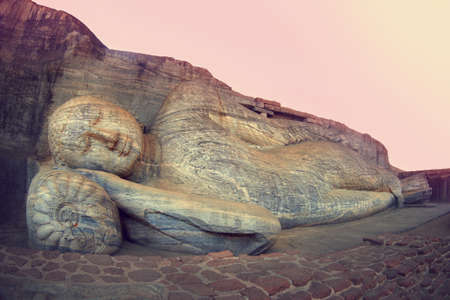 Sleeping Buddha statue in Polonnaruwa, Sri-Lanka. Buddha attained nirvana, and lay down to sleep. の写真素材