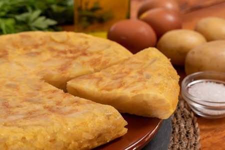 Spanish omelette with potatoes and onion, typical Spanish cuisine. Tortilla espanola. Rustic dark backgroundの写真素材