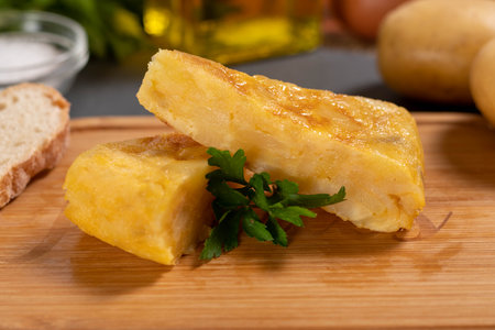 Spanish omelette with potatoes and onion, typical Spanish cuisine. Tortilla espanola. Rustic dark backgroundの写真素材