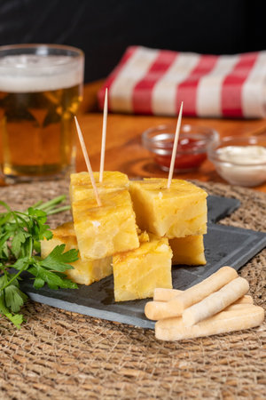 Spanish omelette with potatoes and onion, typical Spanish cuisine. Spanish tortilla. Rustic dark backgroundの写真素材