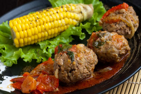 Meatballs served with corn and lettuceの写真素材