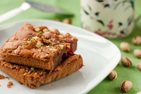 Chocolate cake with raspberries and pistachioの写真素材
