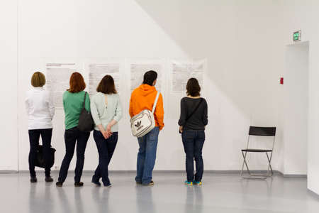 MOSCOW - MAY 1: People reading an interview at the Wim Wenders photography exhibition 'Pictures from the Surface of the Earth' at Multimedia Art Museum in Moscow, Russia, on May 1, 2012のeditorial素材