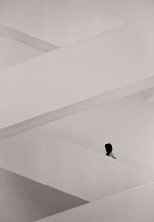 Moscow, Russia - May 1, 2012: A girl is ascending the staircase in Multimedia Art Museum (House of Photography)のeditorial素材