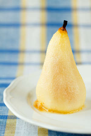 A baked pear on a colored backgroundの写真素材