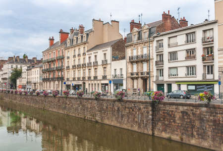 View on beautiful embankment of River Vilaine decorated with flowers in Rennes, Brittany, France