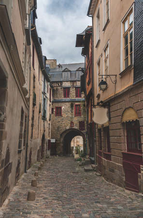 Narrow winding ancient street with cobblestone road and historic houses in old town in Rennes, Brittany, Franceの写真素材