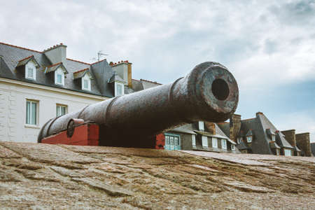 Old aged cannon facing the sea put on display on walls of Saint-Malo ramparts, Brittany, France