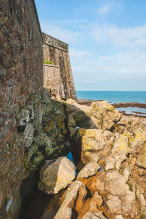 Fragment of Fort National, ancient fortress on tidal island Petit Be, surrounded by stones and rocks in Saint-Malo, Brittany, Franceの写真素材