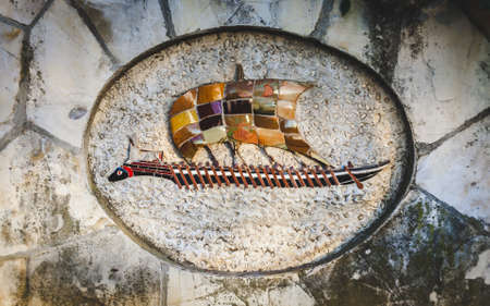 Ancient Roman style mosaic panel of longship with sail and oars in Castle Hill park in Nice, Cote...