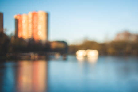 Defocused background with tall building standing near big lake. For wallpaper, backgroundの写真素材
