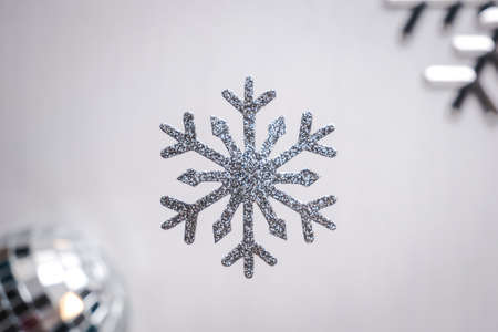 Silver glittering snowflake Christmas decoration on white background