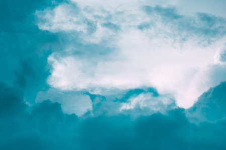 Turquoise blue and white clouds in sky. Copy space. For background and wallpaperの写真素材