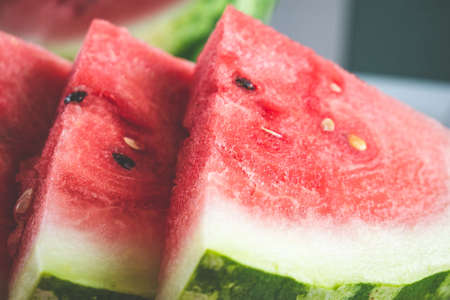 Close up of triangular slices of ripe fresh watermelon with red flesh. Selective focusの写真素材