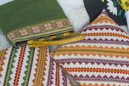 Green bag and orange cushions with the Slavic ornamentsの写真素材