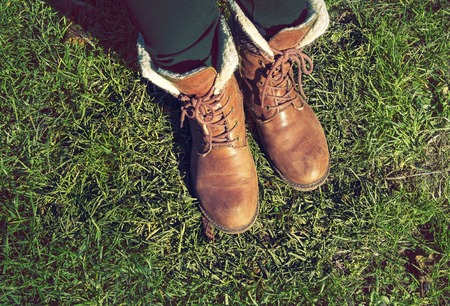 girl in shoes standing on the grass, walk in the park.の写真素材