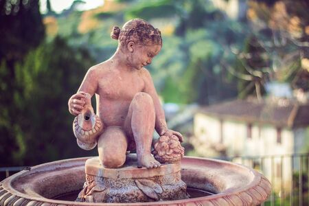 Statue figure of a young girl. Fountain Decoration on the street in Florence, Italy.の写真素材