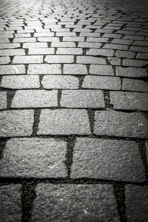 Background of cobblestones on the pavement in the old town.の写真素材