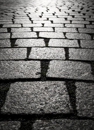 Background of cobblestones on the pavement in the old town.の写真素材