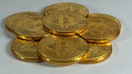 Rotating Stack Of Gold Bitcoins On Turntable.