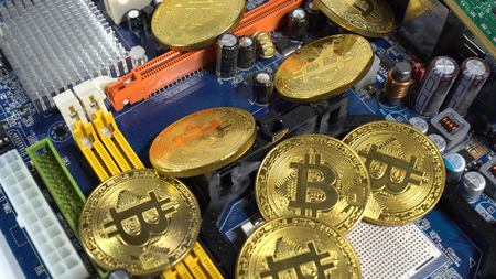 several coins of bitcoins and a strip of electronic memory on a light background.の写真素材