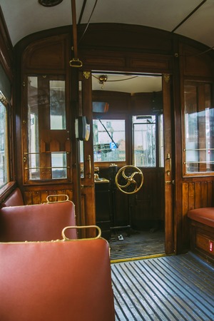 In the car of an old tram. Seats for passengers and control cabinの写真素材