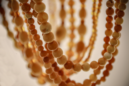 Simple beads made from natural yellow amber. Beads close-upの写真素材