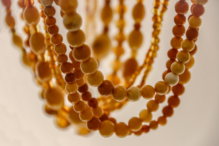 Simple beads made from natural yellow amber. Beads close-upの写真素材
