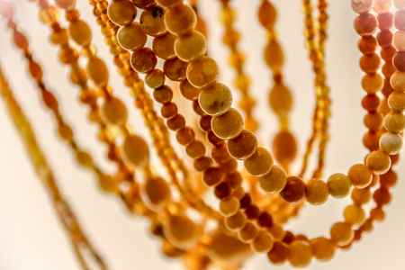 Simple beads made from natural yellow amber. Beads close-upの写真素材