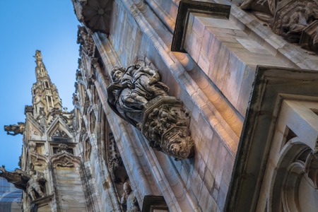 Facade, statues and decorative elements on the roof of the Duomo in Milan.の写真素材