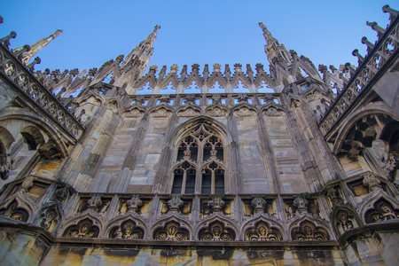 Facade, statues and decorative elements on the roof of the Duomo in Milan.の写真素材