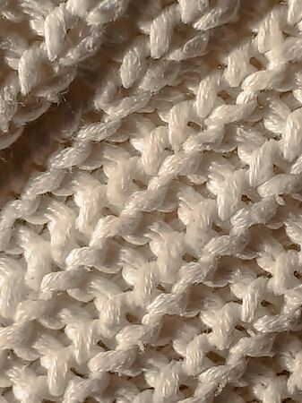 Knitted pattern from white wool. knitted fabric, handmade.