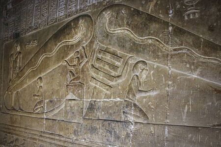 Mysterious murals on the walls of the Temple of Dendera Hathor , near the city of Ken. Electric...