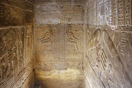 Mysterious murals on the walls of the Temple of Dendera Hathor , near the city of Ken. Electric...