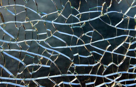 horizontal cracks on the glass of water on a blue backgroundの写真素材