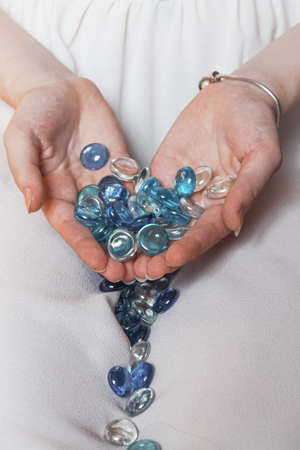 Many beautiful beads in the hands of a girlの写真素材