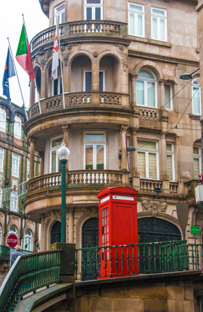 Red telephone booth in the historic center in Porto, Portugal.の写真素材