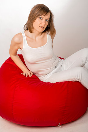 Young woman in white tight clothes posing in studio.の写真素材