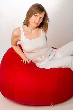 Young woman in white tight clothes posing in studio.の写真素材