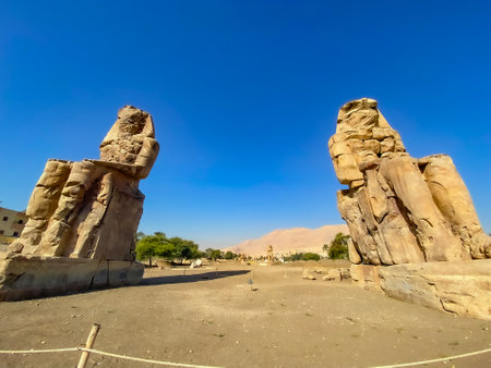Colossi of Memnon, two massive stone statues representing the pharaoh, Luxor, Egypt.の写真素材