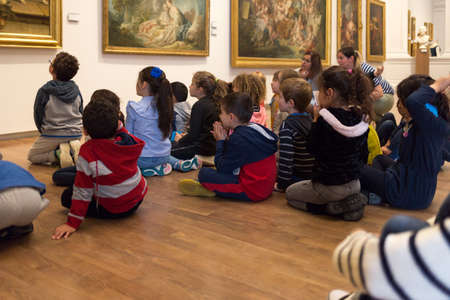 Angers, France - June 21 2019: Children visit the Museum of Fine Arts. kids inside museum, activity for preschoolers. childrens sitting on the floor listening to the guideのeditorial素材