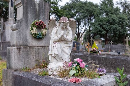 stoned angel on the tombstone in the public cemetery, grave sculpture, RIPの写真素材