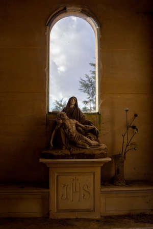 Angers, Maine et Loire, France - October 27 2020: cementery vintage sculpture of madonna, tombestone, sadness concept, catholic comunity, holy light ray effectのeditorial素材