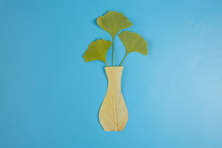 DIY autumn nature craft for kids, how to make an vase foliage, homemade handicraft from dry leavesの写真素材
