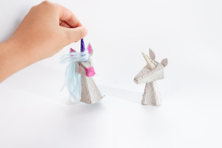 Tutorial on how to make unicorn from recycled paper. Kids craft, creative and sustainable. Perfect for DIY projects, turning waste paper into beautiful unicorn, imaginative play and recycling.の写真素材