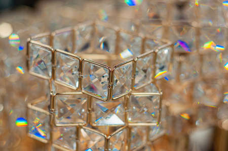Decorative glass and gilded metal decoration on defocused background. glare and reflections with blurの写真素材