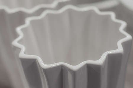 Abstract star made of white ceramic on defocused background. ribbed geometric shape, volumetric decor detailsの写真素材
