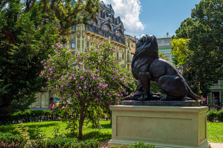 Odessa, Ukraine. July 22.2021. City center. A park with flowering Hibiscus tree, a historical building, a lion monumentのeditorial素材