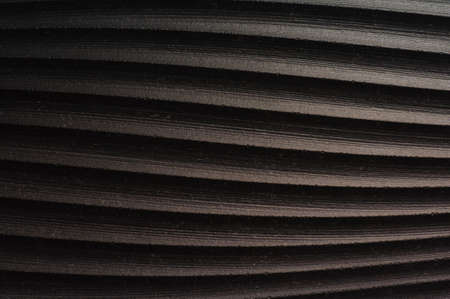 Black wavy abstract background. Curved embossed ceramic tile texture, grainy surfaceの写真素材