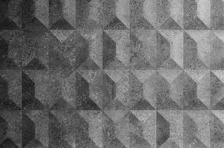 Texture of ceramic tiles with embossed rhombuses and pyramids, granular surface. Gray geometric...